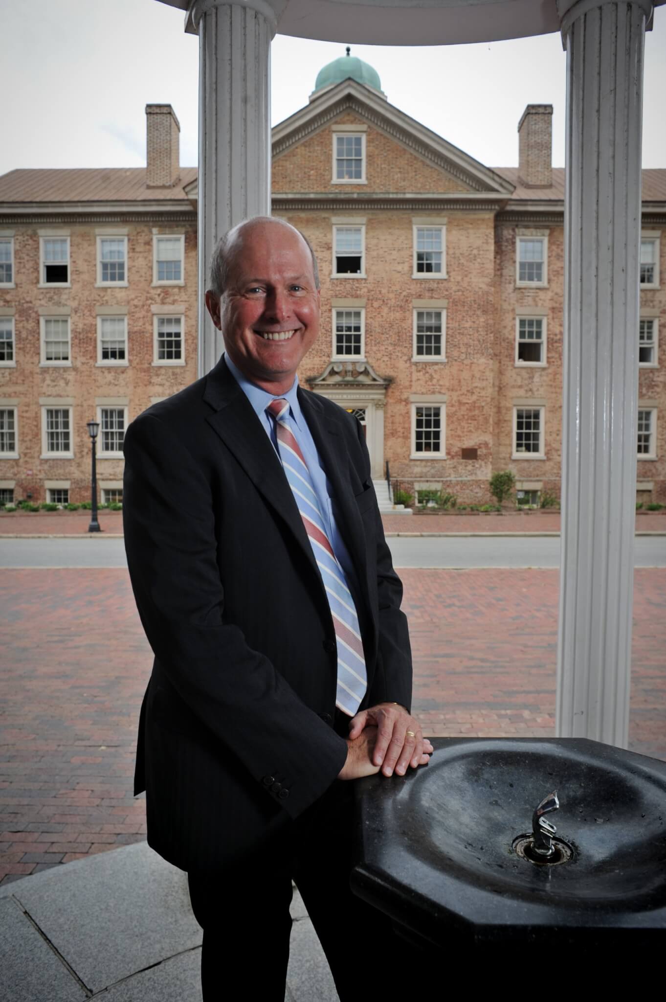 Provost James Dean at the Old Well at the University of North Carolina at Chapel Hill. In background is South Building the main administrative building.